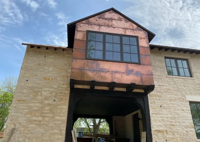 Copper metal panel facade on a stone building for Roof Repair in Warrenton